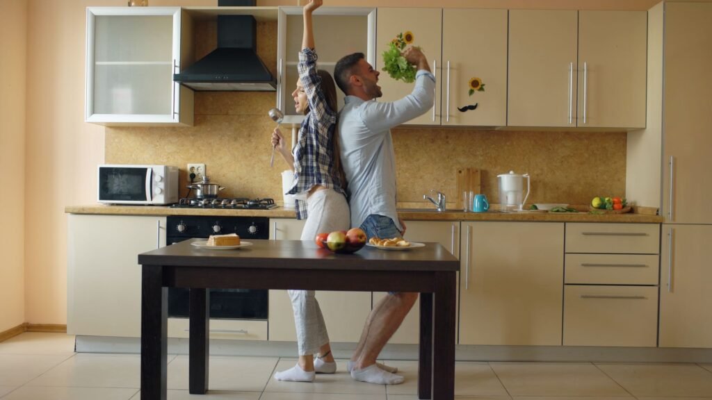 couple dancing together while cooking food