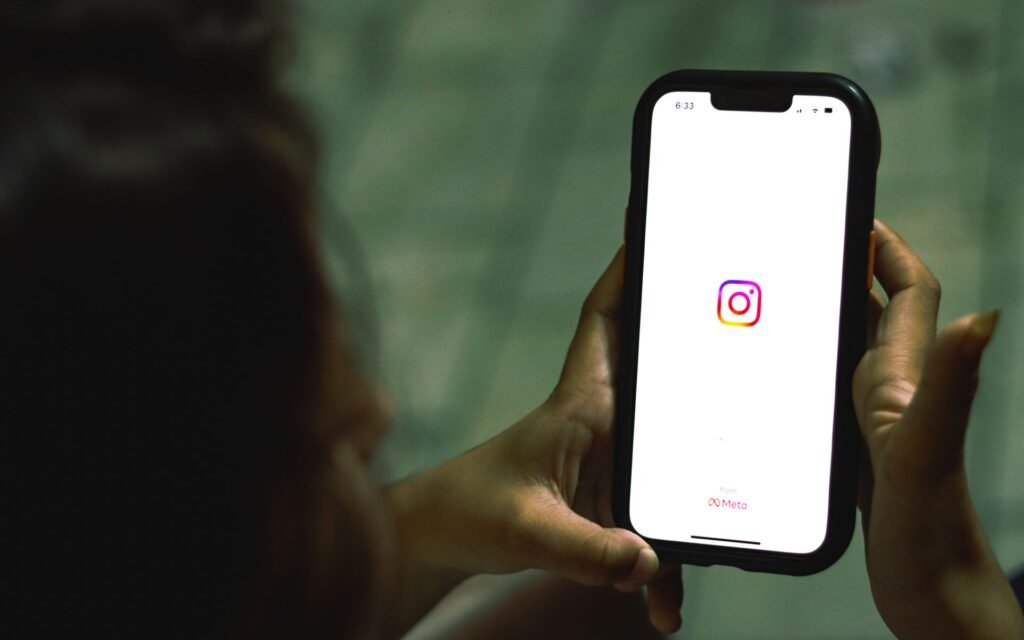 looking at instragram logo on mobile phone